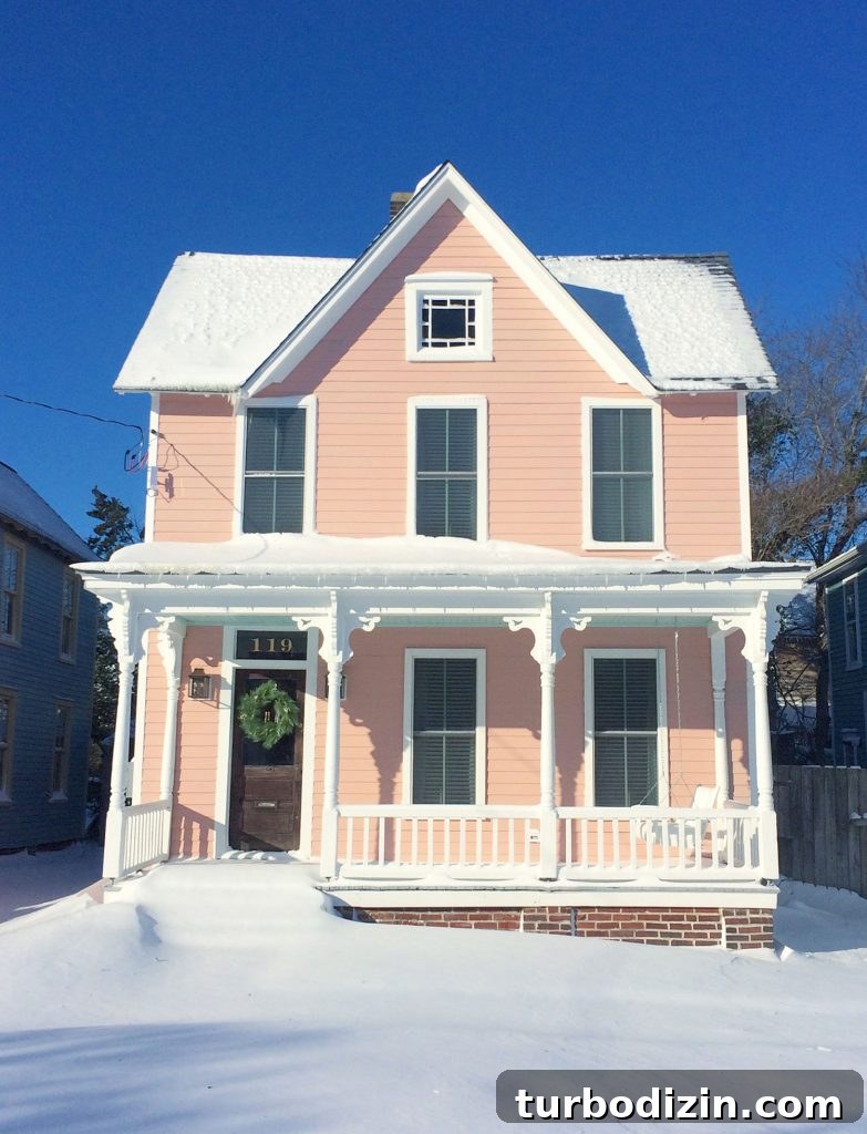 Snow covered historic pink beach house