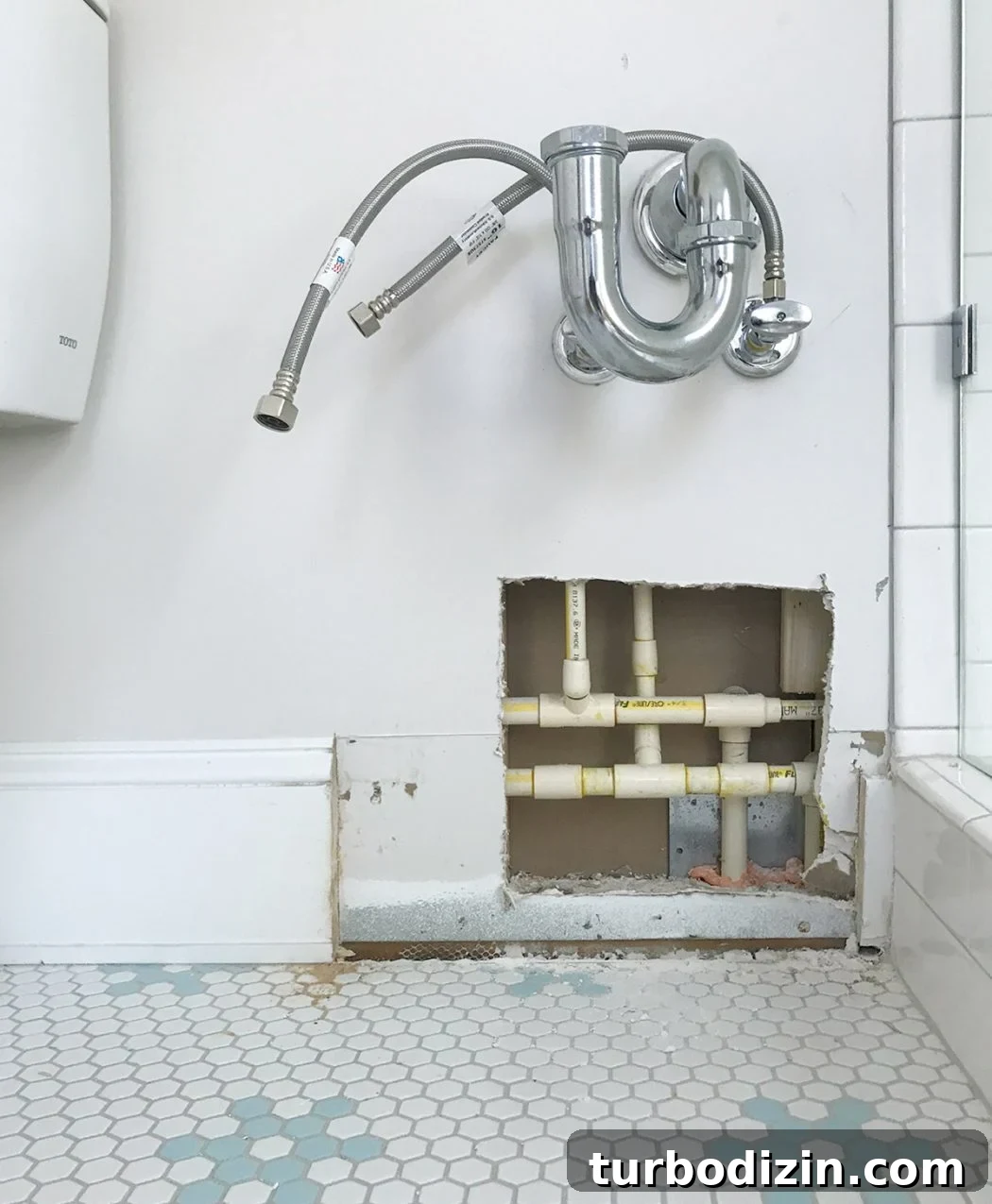 Bathroom leak exposed in wall