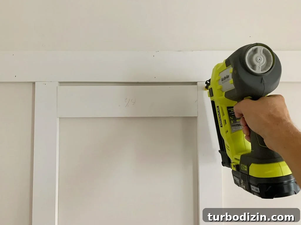 Board and Batten Tutorial: Step-by-Step Guide for Stunning Walls 11 Installing Vertical Battens Using Nail Gun And Wood Spacer