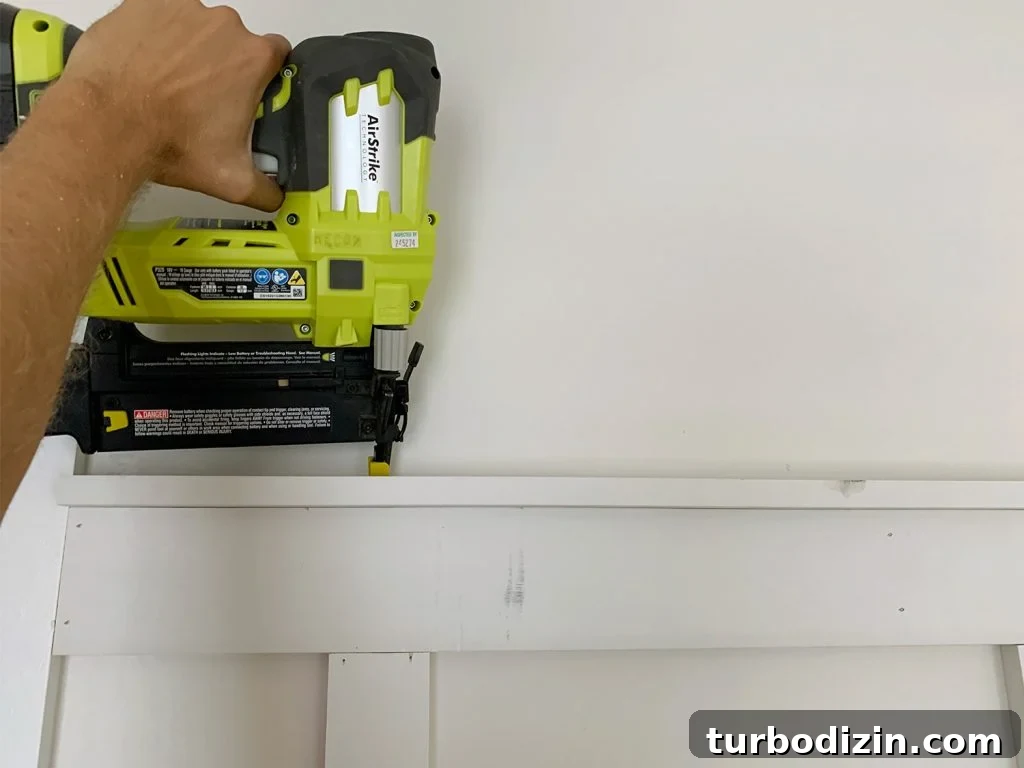 Board and Batten Tutorial: Step-by-Step Guide for Stunning Walls 14 Nail Gun Attaching Top Rail Lip Across Board And Batten