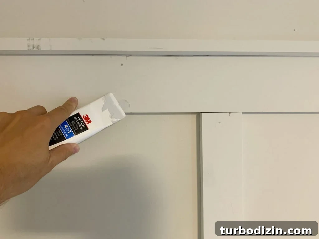 Board and Batten Tutorial: Step-by-Step Guide for Stunning Walls 15 Using Spackling Tool To Fill Nail Holes On Board And Batten