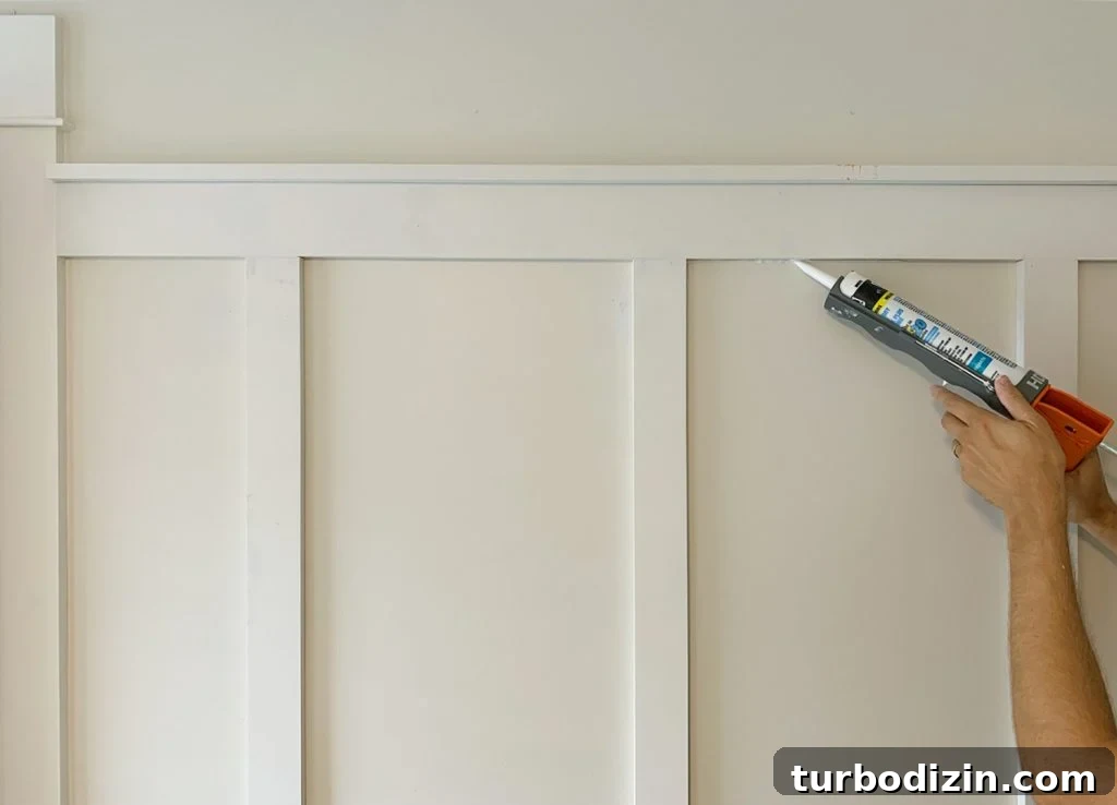 Board and Batten Tutorial: Step-by-Step Guide for Stunning Walls 17 Applying Caulk Bead To Seams On Board And Batten Installation