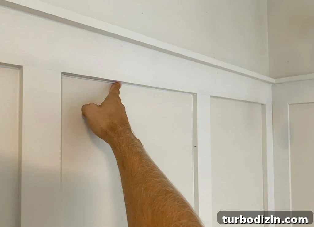 Board and Batten Tutorial: Step-by-Step Guide for Stunning Walls 18 Finger Wiping Caulk Smooth Along Seams In Board And Batten
