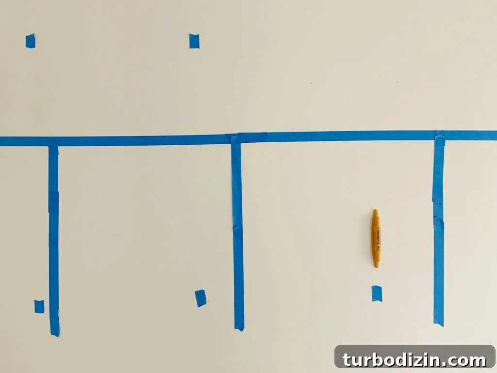 Board and Batten Tutorial: Step-by-Step Guide for Stunning Walls 7 Marking Studs With Blue Painters Tape Using Stud Buddy Tool