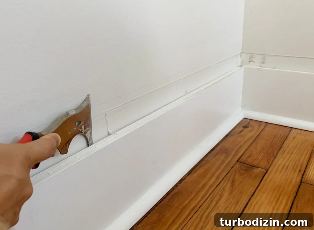 Board and Batten Tutorial: Step-by-Step Guide for Stunning Walls 9 Scraping Old Caulk For Smooth Wall Above Baseboard
