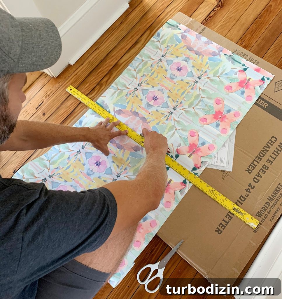 Cutting Roll Of Peel And Stick Wallpaper With Knife And Ruler