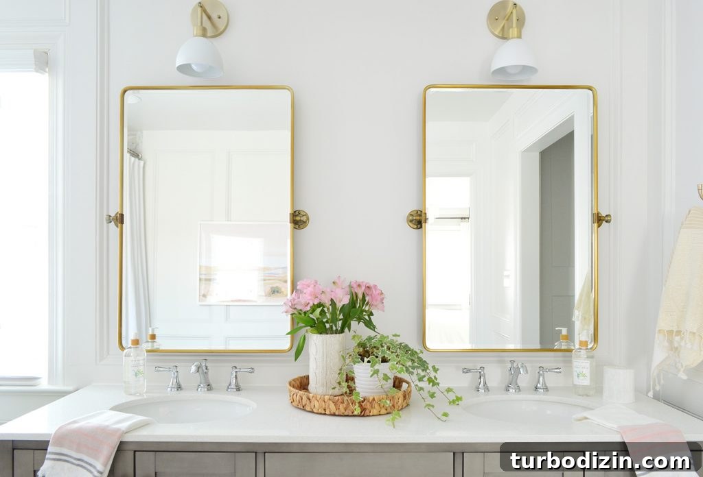 Managing Renovation Stress: 5 Practical Tips for a Smoother Remodel 11 Two gold pivot mirrors over gray bathroom double vanity