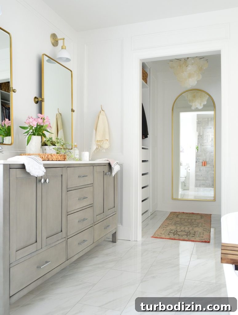 Managing Renovation Stress: 5 Practical Tips for a Smoother Remodel 12 Marlbe bathroom with gray double vanity and doorway into walk in closet