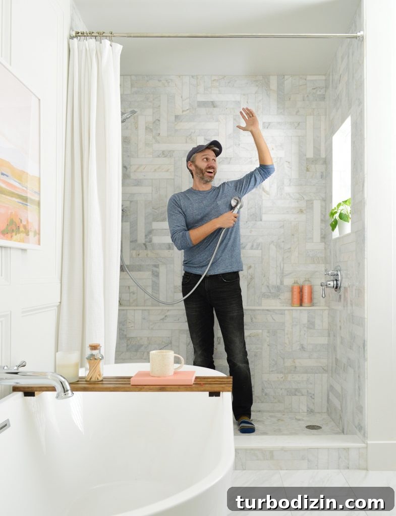Managing Renovation Stress: 5 Practical Tips for a Smoother Remodel 4 John standing in marble tiled shower pretending to shower