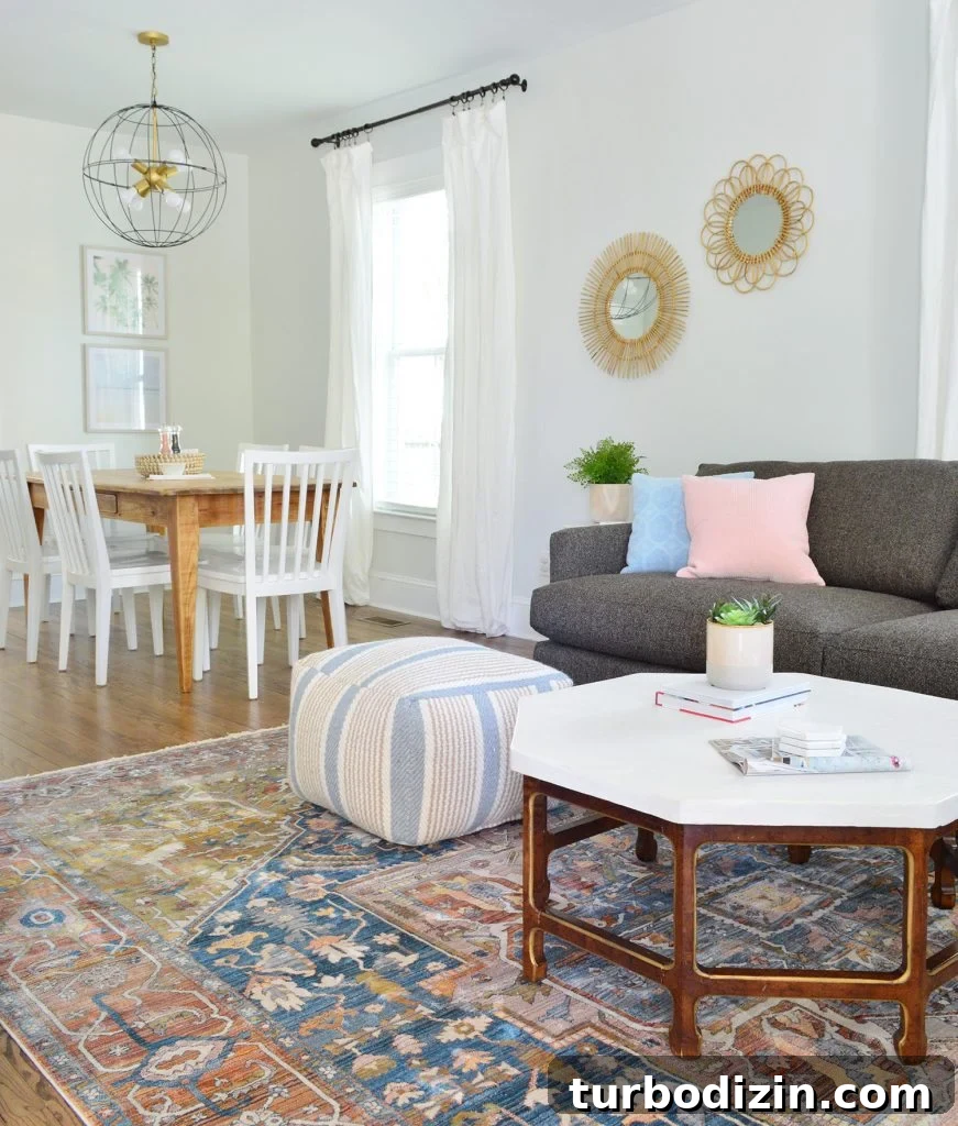Top Picks We Own and Love — On Sale Right Now 17 Neutral Traditional Rug With Crate And Barrel Sofa And Pouf With Dining In Background