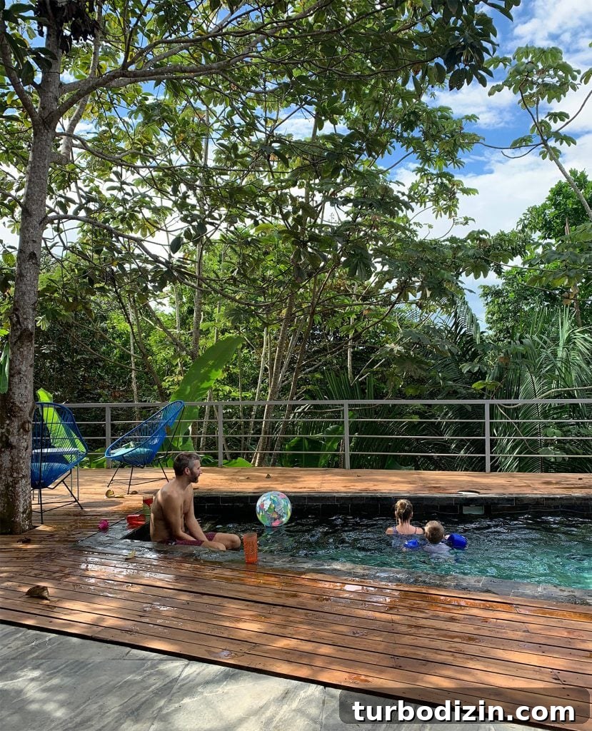 Dad Playing With Kids At Pool In Costa Rica Jungle