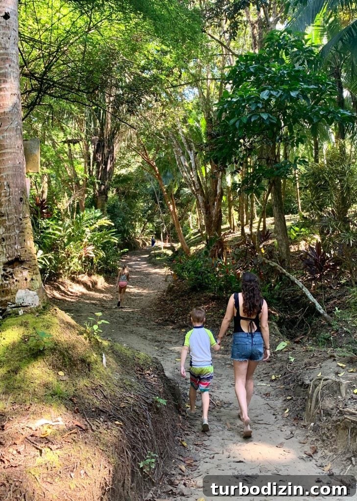 Mom Walking With Young Kids To Secret Playa Biesanz Beach In Costa Rica