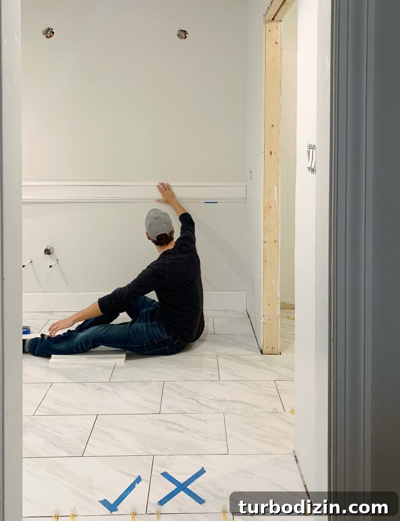 How to Install Decorative Wall Molding for a Polished Look 6 John Holding Test Piece Of Wall Molding In Bathroom