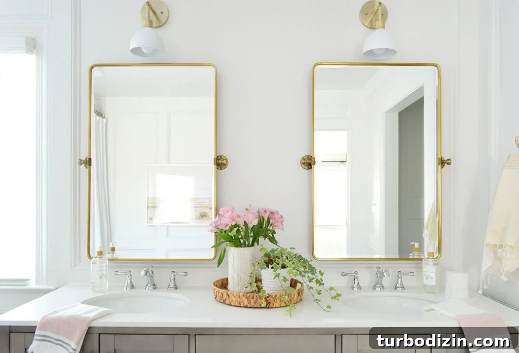 Bathroom Makeover Before and After Photos + Exact Cost Breakdown 8 Brass Pivot Mirrors Over Double Vanity With Traditional Moldings And Shades Of Light Dapper Sconces
