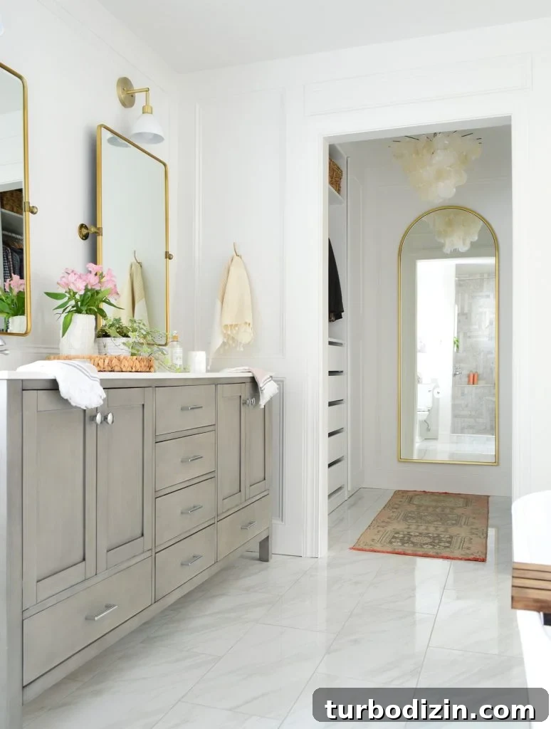 Bathroom Makeover Before and After Photos + Exact Cost Breakdown 16 Double Gray Bathroom Vanity Next To Entrance To Large Walk-In Closet With Arch Mirror