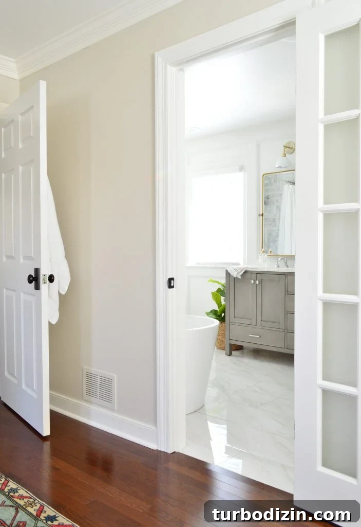 Bathroom Makeover Before and After Photos + Exact Cost Breakdown 17 View Through Bathroom Door From Bedroom To View Of Double Vanity And Window In Marble Bathroom