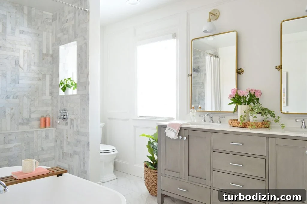 Bathroom Makeover Before and After Photos + Exact Cost Breakdown 18 Marble Bathroom With Herringbone Tile Walk In Shower And Double Gray Vanity And Brass Pivot Mirrors
