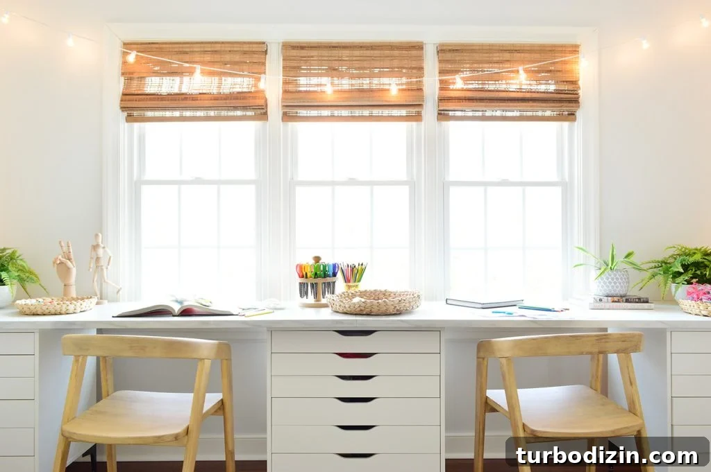 Straight View Of Kids Oversized Art Desk With Faux Marble Desktop In Front Of Window With String Lights