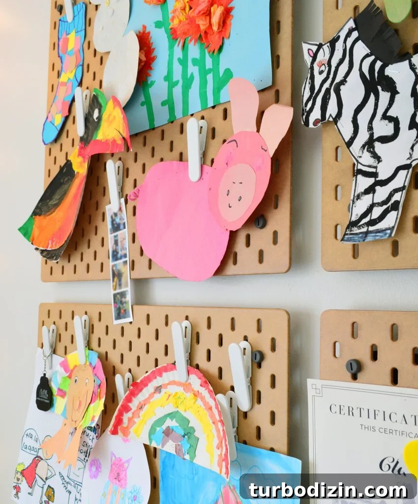 Ikea Skadis Pegboard Organizer With Kids Artwork Clipped Up For Display
