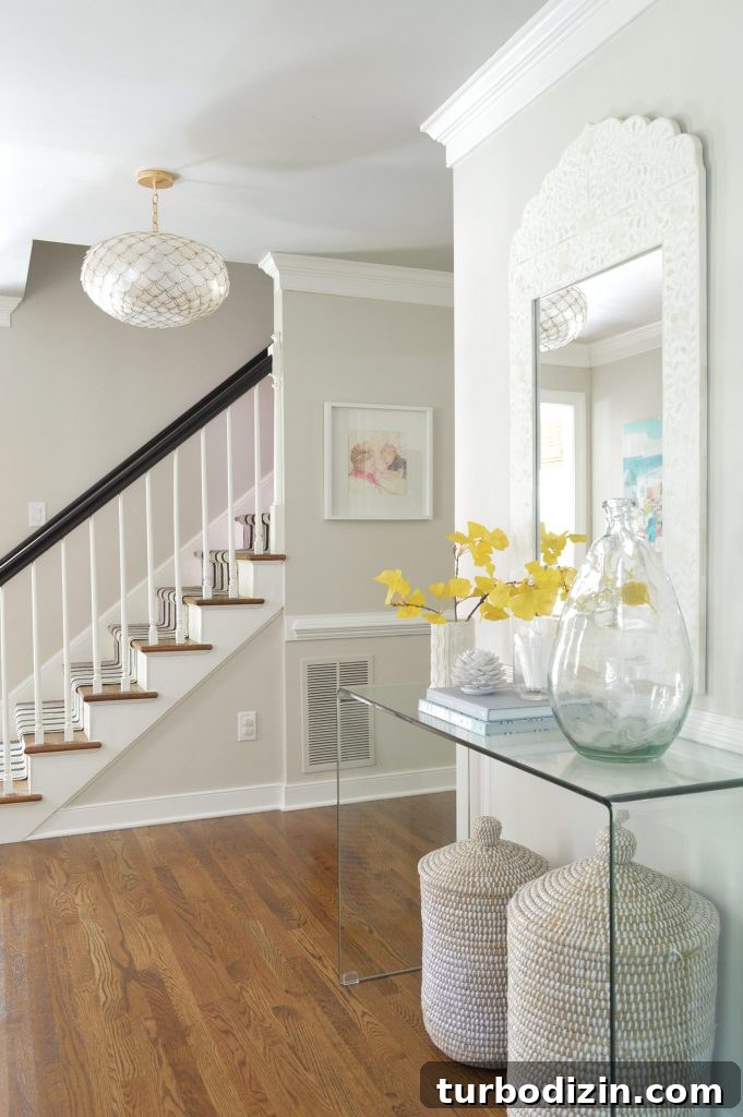 How to Declutter and Downsize Your Home: A Step-by-Step Guide 6 Neutral foyer with capiz light fixture