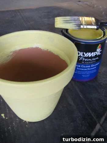img_2788 adding yellow paint to terra cotta pot