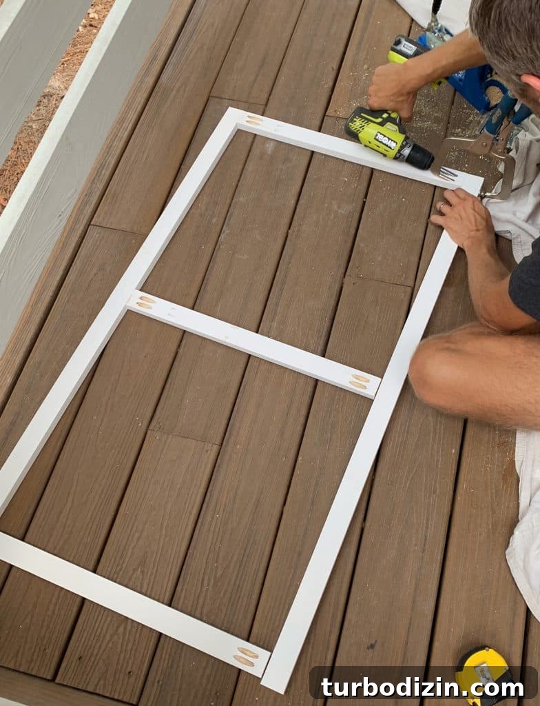 Simple DIY Headboard Ideas to Build Yourself in a Weekend 6 John building simple wood frame with 1x2 boards and pocket holes in figure 8 shape