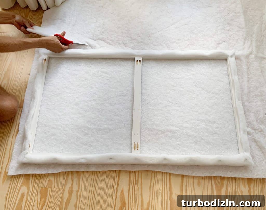 Simple DIY Headboard Ideas to Build Yourself in a Weekend 10 Cutting second layer of fabric batting for attaching to DIY upholstered headboard