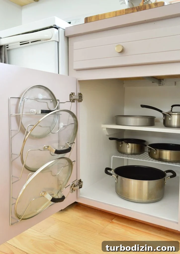 Maximize Space: Smart Organization Ideas for Small Kitchen Cabinets 10 Pots and pans organized in small kitchen with lid mounted on cabinet door