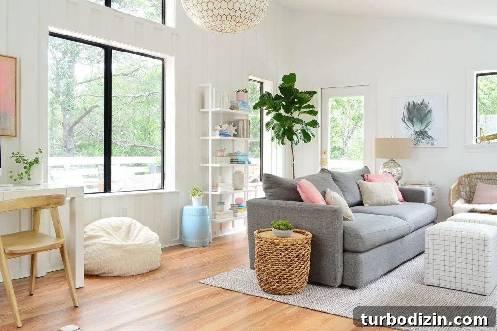 How We Hung a Massive Serena & Lily Chandelier in Our Home 2 Wide Shot of Upstairs Living Room With Big Windows To Trees