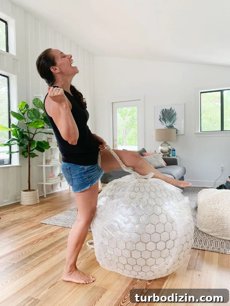 How We Hung a Massive Serena & Lily Chandelier in Our Home 4 Sherry Pretending To Reenact Miley Cyrus Wrecking Ball On Large Capiz Globe Light