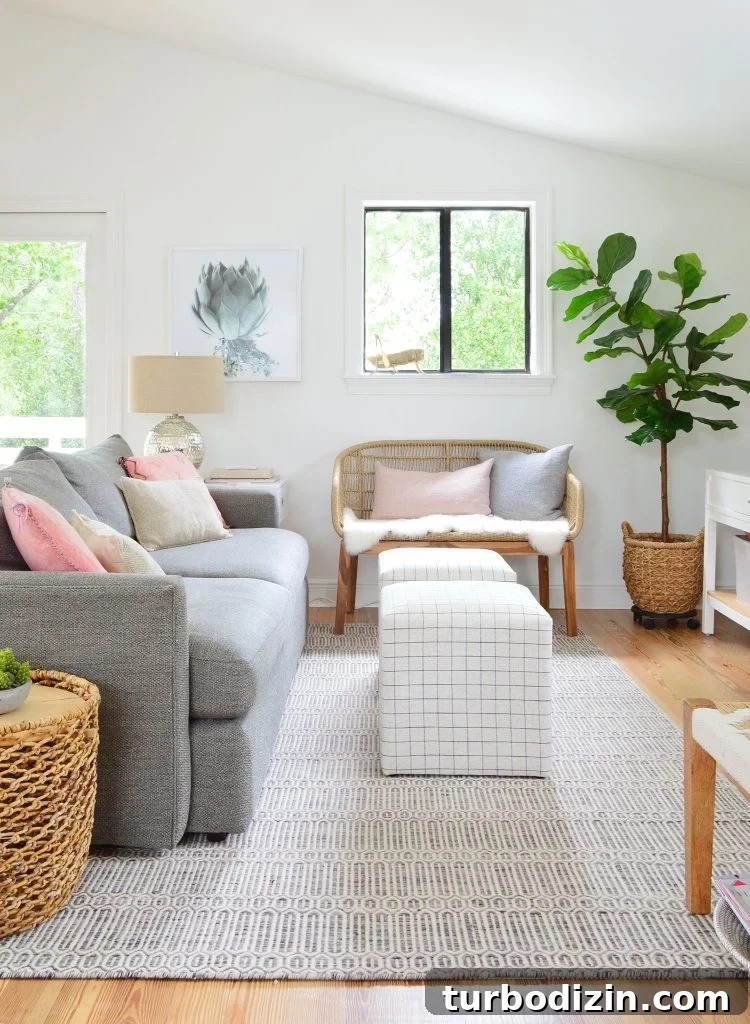 How We Hung a Massive Serena & Lily Chandelier in Our Home 9 Family Room With Couch Striped Ottomans And Woven Bench