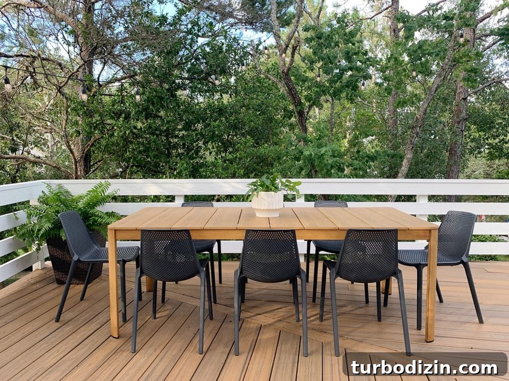 Metal Outdoor Dining Table With Eight Black Plastic Chairs