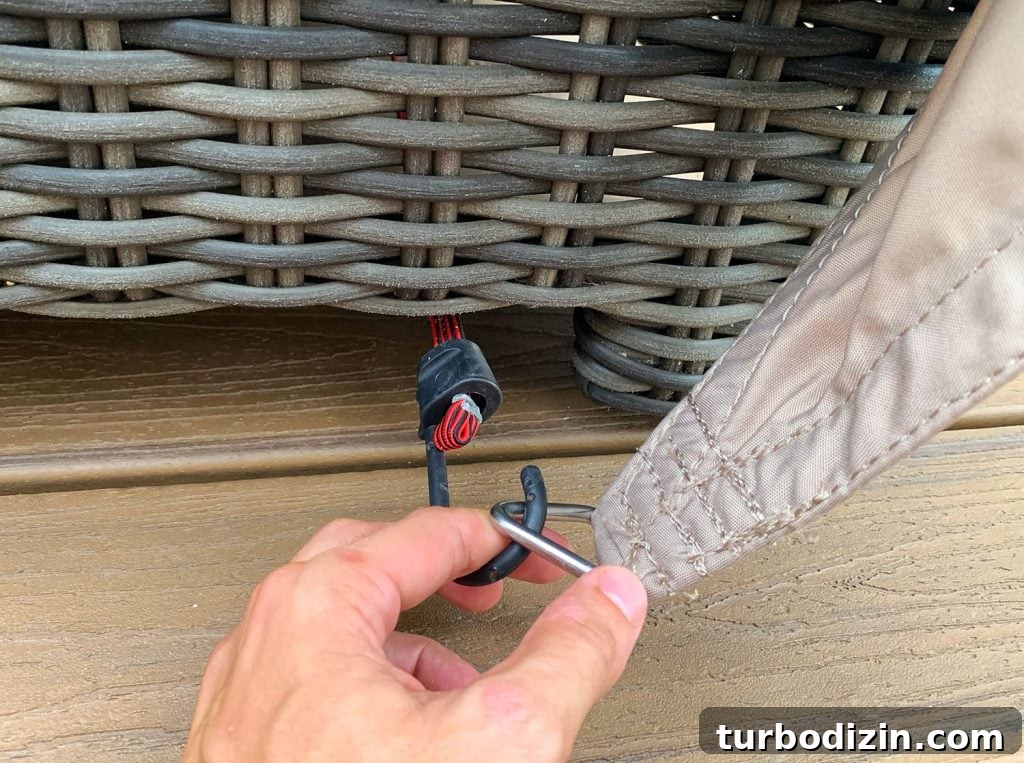 Close Up Of Bungee Hook Looping Over Ring On Sun Sail Cover