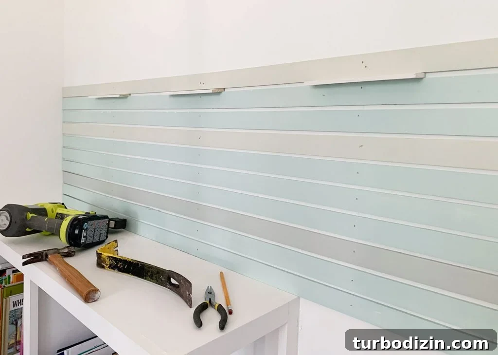 How to Create a Colorful Wood Accent Wall: DIY Guide 13 First Section Of Painted Wood Lattice Strips Attached To Wall Using Spacers