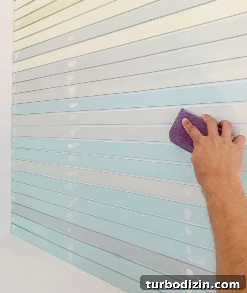 How to Create a Colorful Wood Accent Wall: DIY Guide 17 Hand Sanding Spackled Holes On Striped Wall Treatment