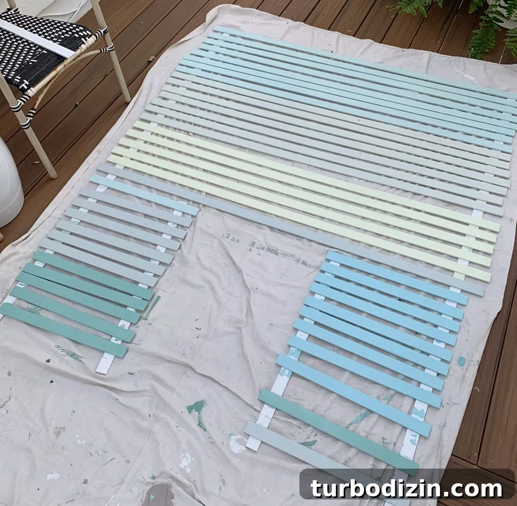 How to Create a Colorful Wood Accent Wall: DIY Guide 9 Painted Lattice Strips Laid Out On Deck In Various Blue Green And Gray Colors