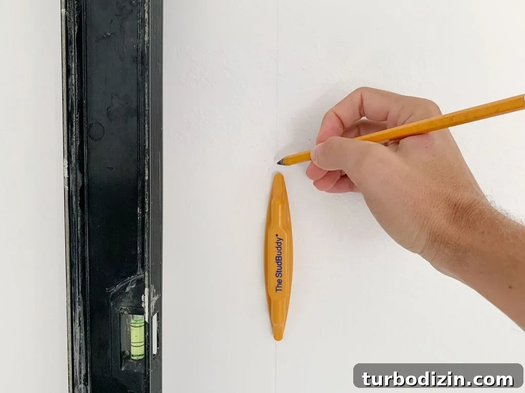 How to Create a Colorful Wood Accent Wall: DIY Guide 10 Hand Marking Vertical Level Line On Wall Using StudBuddy Stud Finder