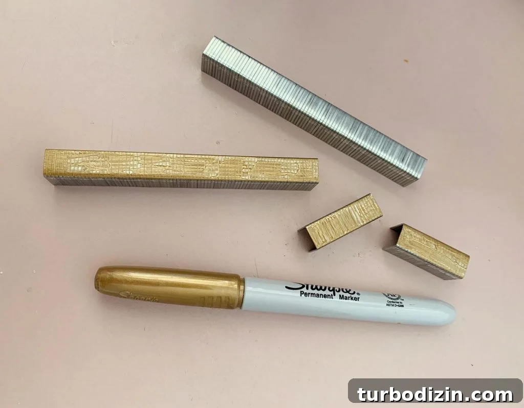 Strips of Staples Colored Gold With Sharpie Marker