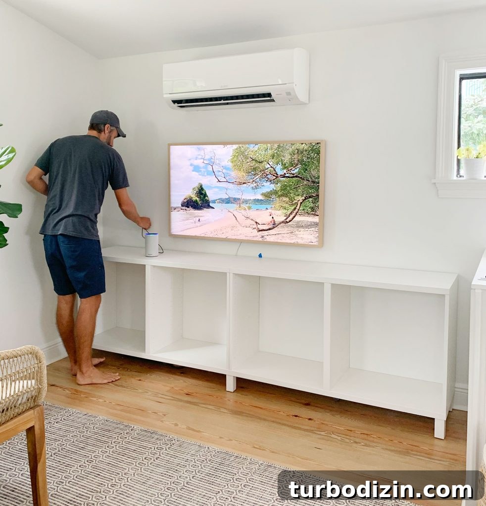 John Working On Installing Ikea Besta Cabinets In Family Room