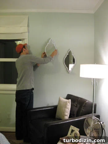 john-hangs-the-sconces-on-the-wall john-hangs-the-sconces-on-the-wall