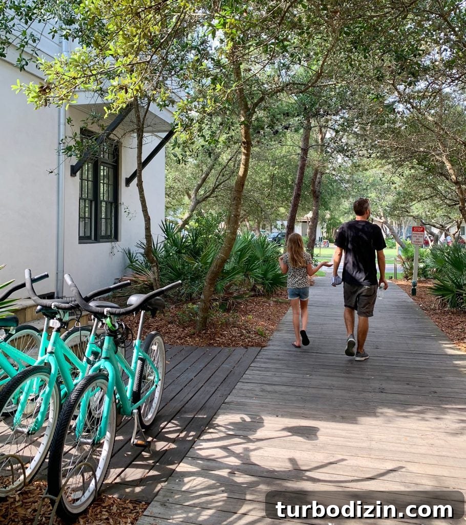 John and daughter walking on wooded walkway next to bikes