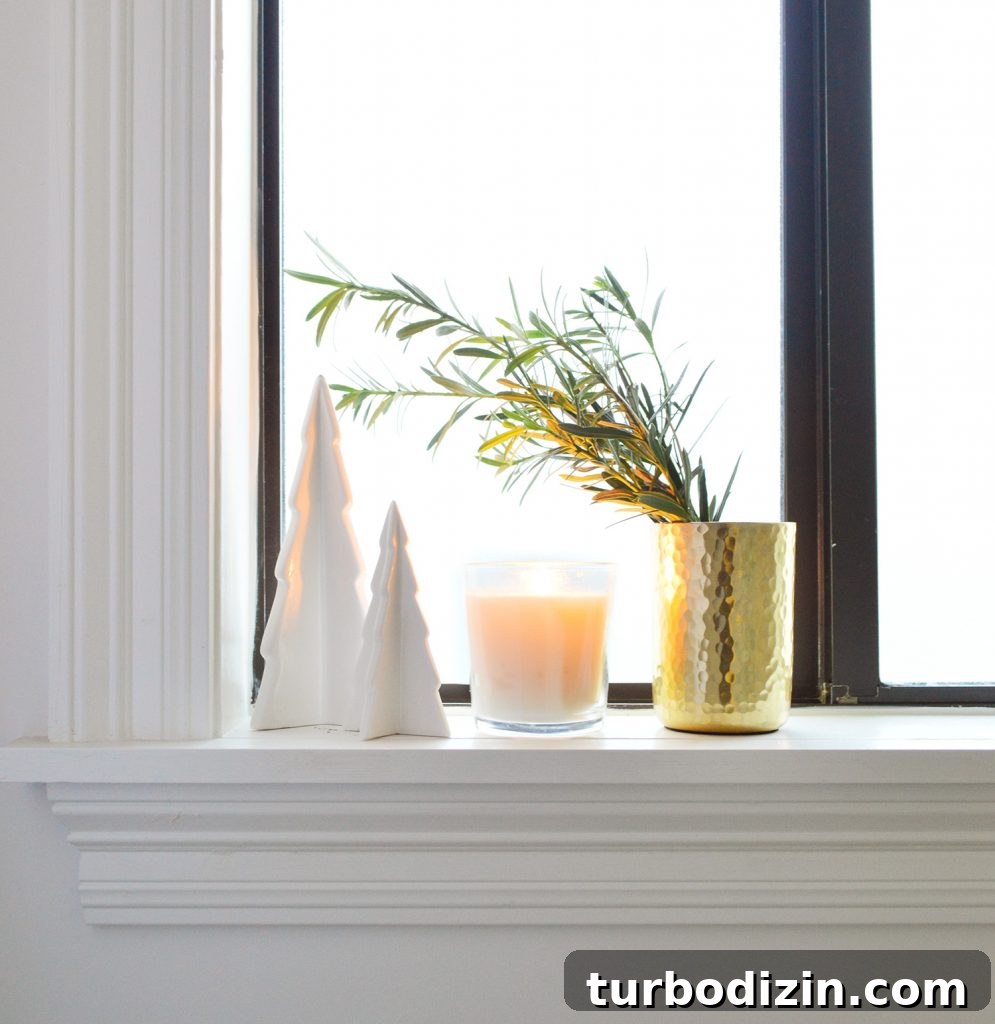 Holiday Decorating Ideas for Our Cozy Downsized Home 10 White Ceramic Trees With Candle And Gold Vase On Bathroom Window Sill