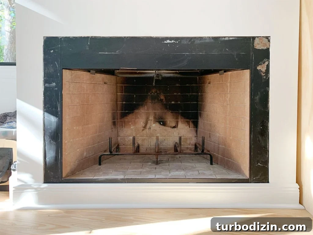 Modern Fireplace Mantel Ideas: Step-by-Step Build Guide 4 Before photo of fireplace with charred brick interior and patchy black metal surround