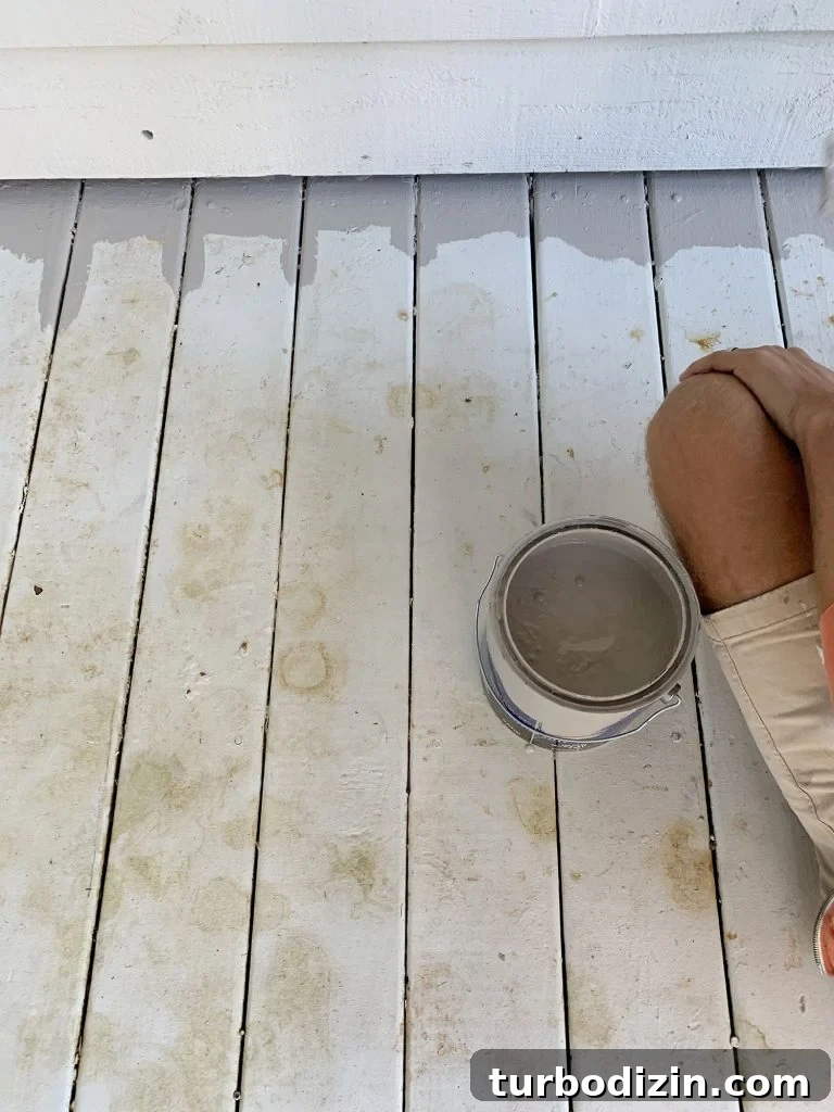 White painted porch floor stained with leaf marks