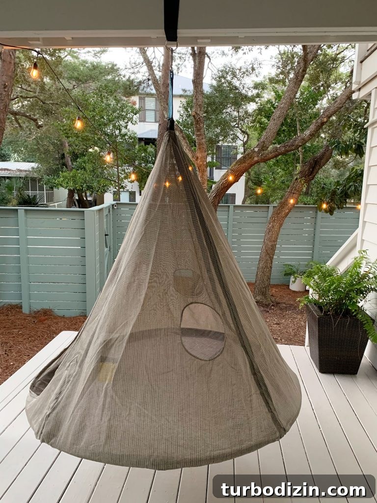 Hanging cone shaped netted tent above painted porch floor