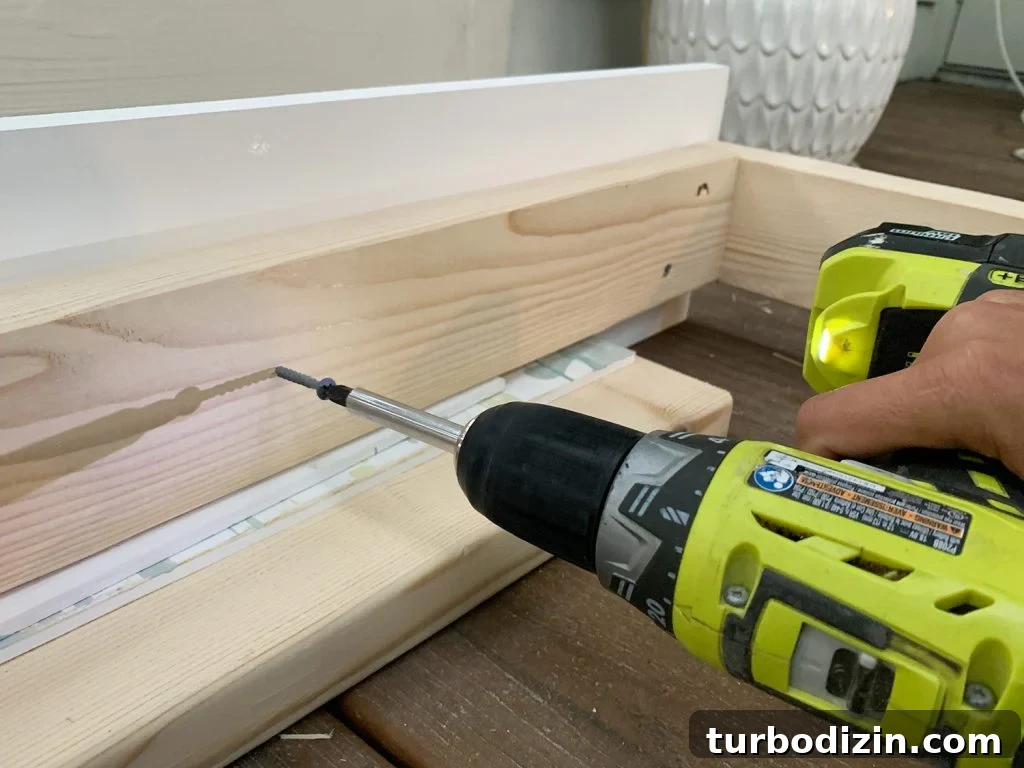 How to Build a Hanging Daybed: Step-by-Step Guide for Your Patio 11 Screwing 2x4 wood frame to white 1x8 board