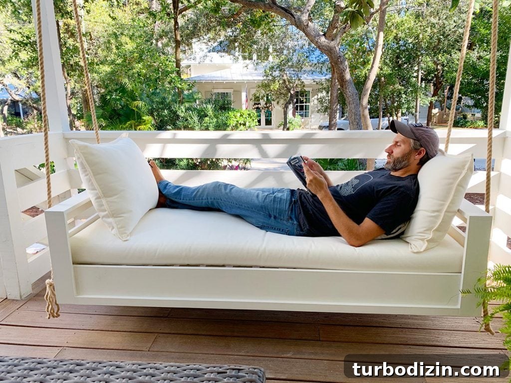 How to Build a Hanging Daybed: Step-by-Step Guide for Your Patio 3 John Laying Fully Stretched Out On Hanging Daybed Swing