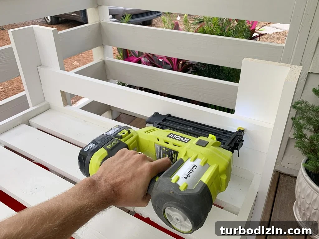 How to Build a Hanging Daybed: Step-by-Step Guide for Your Patio 13 Nailing lower horizontal rail to daybed arm from the inside edge