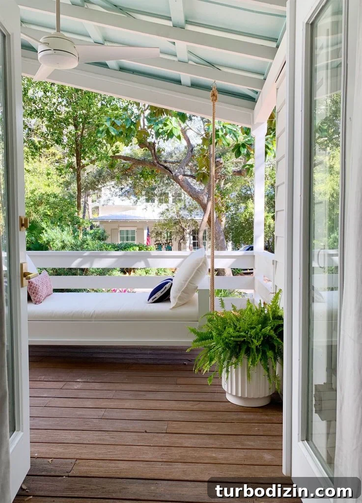 How to Build a Hanging Daybed: Step-by-Step Guide for Your Patio 17 View Of White Hanging Daybed Swing Under Covered Porch Through Open French Doors