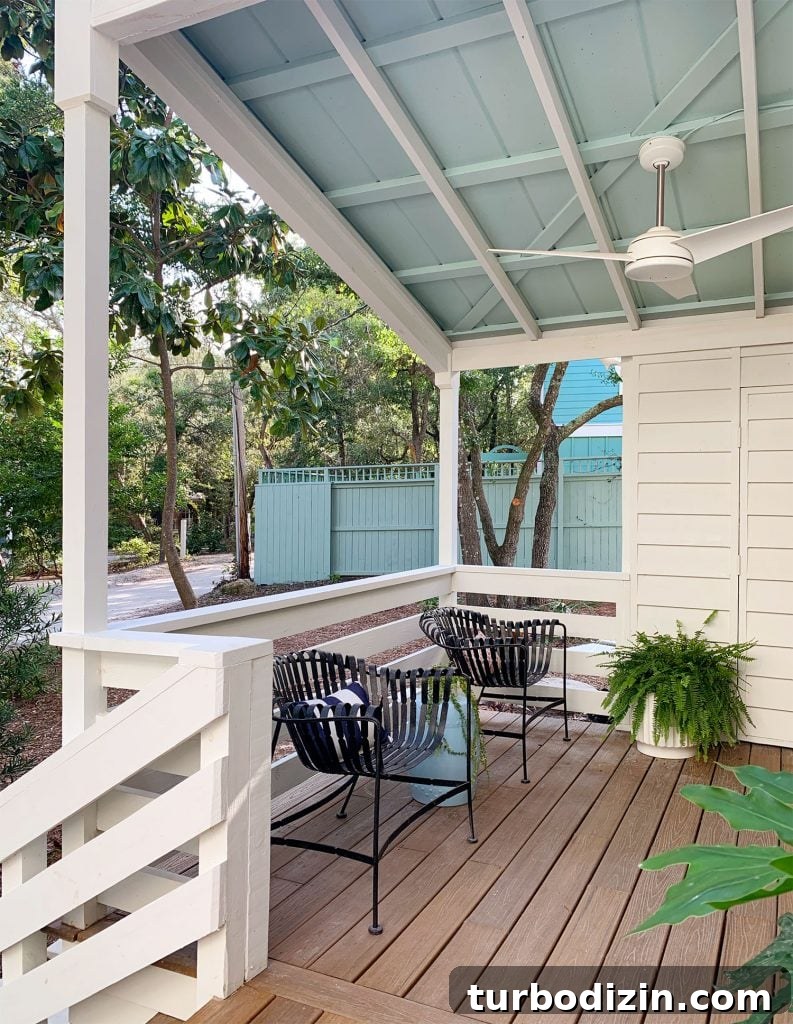 How to Build a Hanging Daybed: Step-by-Step Guide for Your Patio 5 Blue Ceiling On Covered Porch With Ceiling Fan And Black Chairs